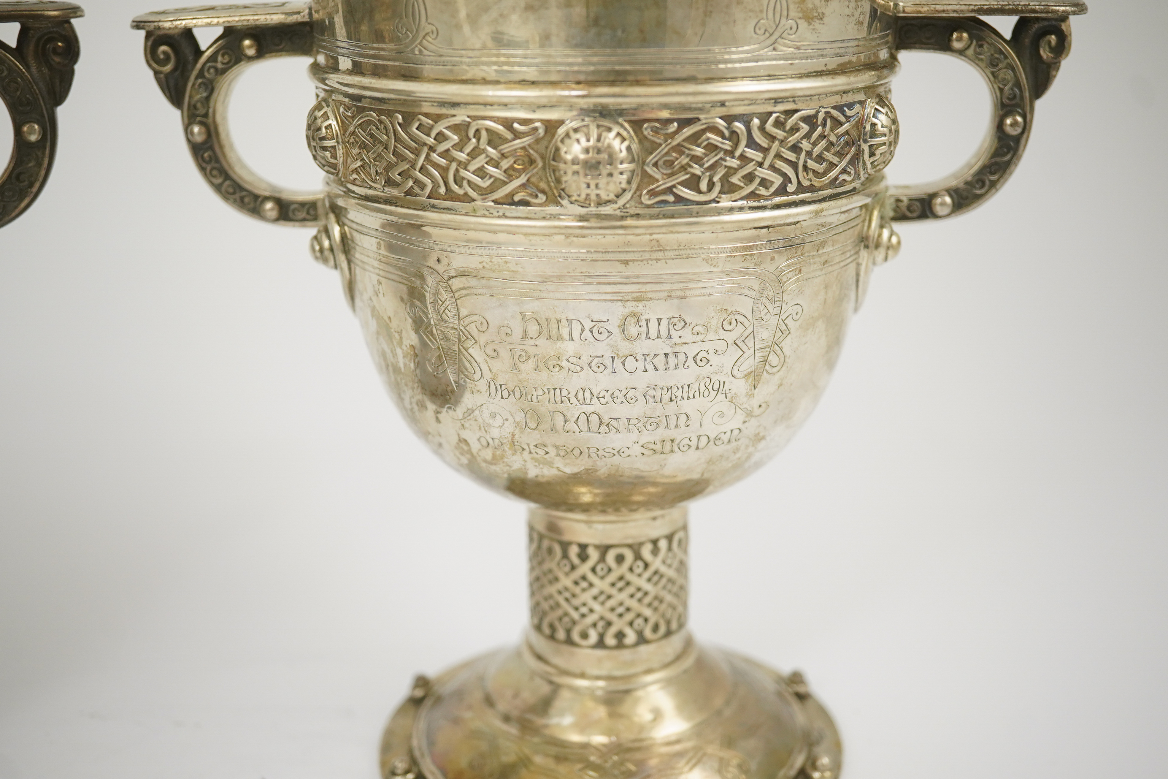 A pair of late Victorian Arts & Crafts Celtic style silver two handled presentation pedestal trophy cups, by Elkington & Co